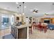 Island kitchen boasts a breakfast bar, stainless appliances, and easy access to a patio for indoor-outdoor living at 7854 Brianna Cheerful Ave, Las Vegas, NV 89178