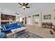 Open-concept living room featuring tile flooring, ceiling fan and comfortable seating at 7854 Brianna Cheerful Ave, Las Vegas, NV 89178