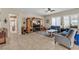 Cozy living room featuring tile floors, ceiling fan and comfortable seating and large windows at 7854 Brianna Cheerful Ave, Las Vegas, NV 89178