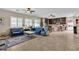Open-concept living room with tile floors, comfortable seating, and seamless flow into the kitchen at 7854 Brianna Cheerful Ave, Las Vegas, NV 89178