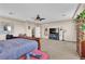 Spacious main bedroom features neutral colors, carpet flooring, ceiling fan, television, and natural light at 7854 Brianna Cheerful Ave, Las Vegas, NV 89178