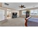 Spacious main bedroom features neutral colors, carpet flooring, ceiling fan, television, and natural light at 7854 Brianna Cheerful Ave, Las Vegas, NV 89178