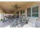 Covered patio with ceiling fans offers an outdoor lounge area at 7854 Brianna Cheerful Ave, Las Vegas, NV 89178