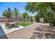 Landscaped backyard featuring artificial turf, dining area, and a rock covered yard at 8221 Ebony Peak St, Las Vegas, NV 89143