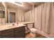 Neutral bathroom featuring a shower-tub combo with modern fixtures and a wooden floor at 8221 Ebony Peak St, Las Vegas, NV 89143
