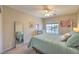 Bright bedroom with a large window, ceiling fan and a cozy bed with decorative pillows at 8221 Ebony Peak St, Las Vegas, NV 89143
