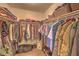 Walk-in closet featuring ample hanging space, shelving, carpet flooring, and organized storage solutions at 8221 Ebony Peak St, Las Vegas, NV 89143