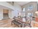 Bright dining area boasts hardwood floors, a large wooden table, and plenty of seating at 8221 Ebony Peak St, Las Vegas, NV 89143