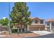 Beautiful home with a three-car garage, desert landscaping, and lush, mature shade trees at 8221 Ebony Peak St, Las Vegas, NV 89143