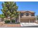 Charming two-story home featuring a three-car garage, manicured landscaping, and mature trees at 8221 Ebony Peak St, Las Vegas, NV 89143