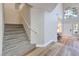 Inviting home foyer with carpeted stairs and wood flooring, leading to a bright and airy living space at 8221 Ebony Peak St, Las Vegas, NV 89143