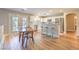 Modern kitchen features stainless steel appliances, white cabinets, and an island with bar seating at 8221 Ebony Peak St, Las Vegas, NV 89143