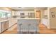 Charming kitchen features stainless steel appliances, white cabinetry, and a breakfast bar with stool seating at 8221 Ebony Peak St, Las Vegas, NV 89143