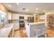 Bright kitchen features stainless appliances, white cabinets, breakfast bar, and tiled backsplash at 8221 Ebony Peak St, Las Vegas, NV 89143