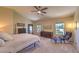 Bright, large main bedroom with ceiling fan and sitting area provides a spacious retreat with ample natural light at 8221 Ebony Peak St, Las Vegas, NV 89143