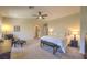 Spacious main bedroom with ceiling fan and seating area offers a relaxing retreat with ample natural light at 8221 Ebony Peak St, Las Vegas, NV 89143
