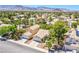 Neighborhood aerial view of homes with lush landscaping, and mountain views in the background at 8324 Tide Pool Dr, Las Vegas, NV 89128