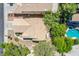 Overhead shot of the home highlighting the roof, surrounding greenery, and a sparkling pool at 8324 Tide Pool Dr, Las Vegas, NV 89128