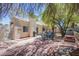 Relaxing backyard featuring stone pavers, barbecue, and shady trees for outdoor enjoyment at 8324 Tide Pool Dr, Las Vegas, NV 89128