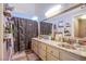 Bright bathroom features a double sink vanity with patterned shower curtain and neutral decor at 8324 Tide Pool Dr, Las Vegas, NV 89128