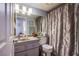 Bathroom featuring tiled walls, ample lighting, framed mirror, and walk in shower at 8324 Tide Pool Dr, Las Vegas, NV 89128