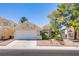 Charming single-story home with a well-manicured lawn and attached two-car garage at 8324 Tide Pool Dr, Las Vegas, NV 89128