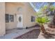 Inviting entryway with a decorative door, tiled walkway, and desert landscaping at 8324 Tide Pool Dr, Las Vegas, NV 89128