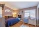 Cozy bedroom with hardwood floors, warm colors, and bright window at 8324 Tide Pool Dr, Las Vegas, NV 89128