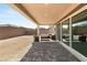 Inviting covered patio perfect for entertaining with an outdoor seating area in backyard at 8575 Nicholas James Ave, Las Vegas, NV 89143