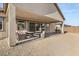 Relaxing covered patio with backyard view and ample space for gatherings, ideal for outdoor enjoyment at 8575 Nicholas James Ave, Las Vegas, NV 89143
