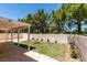 Spacious backyard with a fire pit area, manicured landscaping, and covered patio at 87 Ginger Lily Ter, Henderson, NV 89074