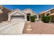 Single-story home featuring desert landscaping, an attached two-car garage, and a tile roof at 87 Ginger Lily Ter, Henderson, NV 89074