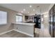Open kitchen boasts stainless appliances, brown cabinetry, recessed lighting, and a breakfast bar at 87 Ginger Lily Ter, Henderson, NV 89074