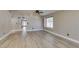 Open living space featuring hardwood floors, neutral paint, and a large window at 87 Ginger Lily Ter, Henderson, NV 89074