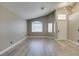 Inviting living room features vaulted ceiling, multiple windows, and modern flooring at 87 Ginger Lily Ter, Henderson, NV 89074