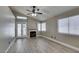Cozy living room with a fireplace, French doors, and large windows for plenty of natural light at 87 Ginger Lily Ter, Henderson, NV 89074