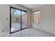 Sliding glass door to backyard, small window, and tile floors create a bright area with backyard access at 8809 Beach Front Dr, Las Vegas, NV 89117