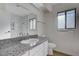 Bathroom with granite countertop, white vanity, and a modern shower and bath combo at 8809 Beach Front Dr, Las Vegas, NV 89117