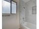 Modern bathroom with stylish, marble-look tiles in the bath and shower area at 8809 Beach Front Dr, Las Vegas, NV 89117