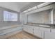 Spacious bathroom featuring dual sinks, soaking tub, and ample counter space at 8809 Beach Front Dr, Las Vegas, NV 89117
