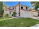 Two-story home with a red tile roof, green lawn, and large palm tree at 8809 Beach Front Dr, Las Vegas, NV 89117