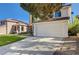 A view of the front of a home with a red tile roof and spacious driveway at 8809 Beach Front Dr, Las Vegas, NV 89117