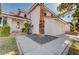 Two-story home with red tile roof, palm tree, and charming front door at 8809 Beach Front Dr, Las Vegas, NV 89117