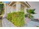 Charming front porch with lush greenery and a red brick staircase at 8809 Beach Front Dr, Las Vegas, NV 89117