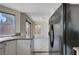 Kitchen with stainless steel refrigerator and granite countertops and view of backyard access and backyard at 8809 Beach Front Dr, Las Vegas, NV 89117