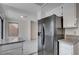 Kitchen featuring stainless steel refrigerator and granite countertops with an entryway to the living room at 8809 Beach Front Dr, Las Vegas, NV 89117