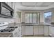 Spacious kitchen area with stainless appliances, granite counters and a window overlooking the backyard at 8809 Beach Front Dr, Las Vegas, NV 89117