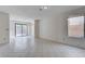 Open living room with tile floors, a sliding glass door to the backyard and a window overlooking the backyard at 8809 Beach Front Dr, Las Vegas, NV 89117