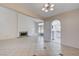 Bright living room with vaulted ceilings, fireplace, tile floors, and an open archway to the kitchen at 8809 Beach Front Dr, Las Vegas, NV 89117