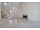 Bright living space with tile flooring, a staircase, and a cozy fireplace at 8809 Beach Front Dr, Las Vegas, NV 89117